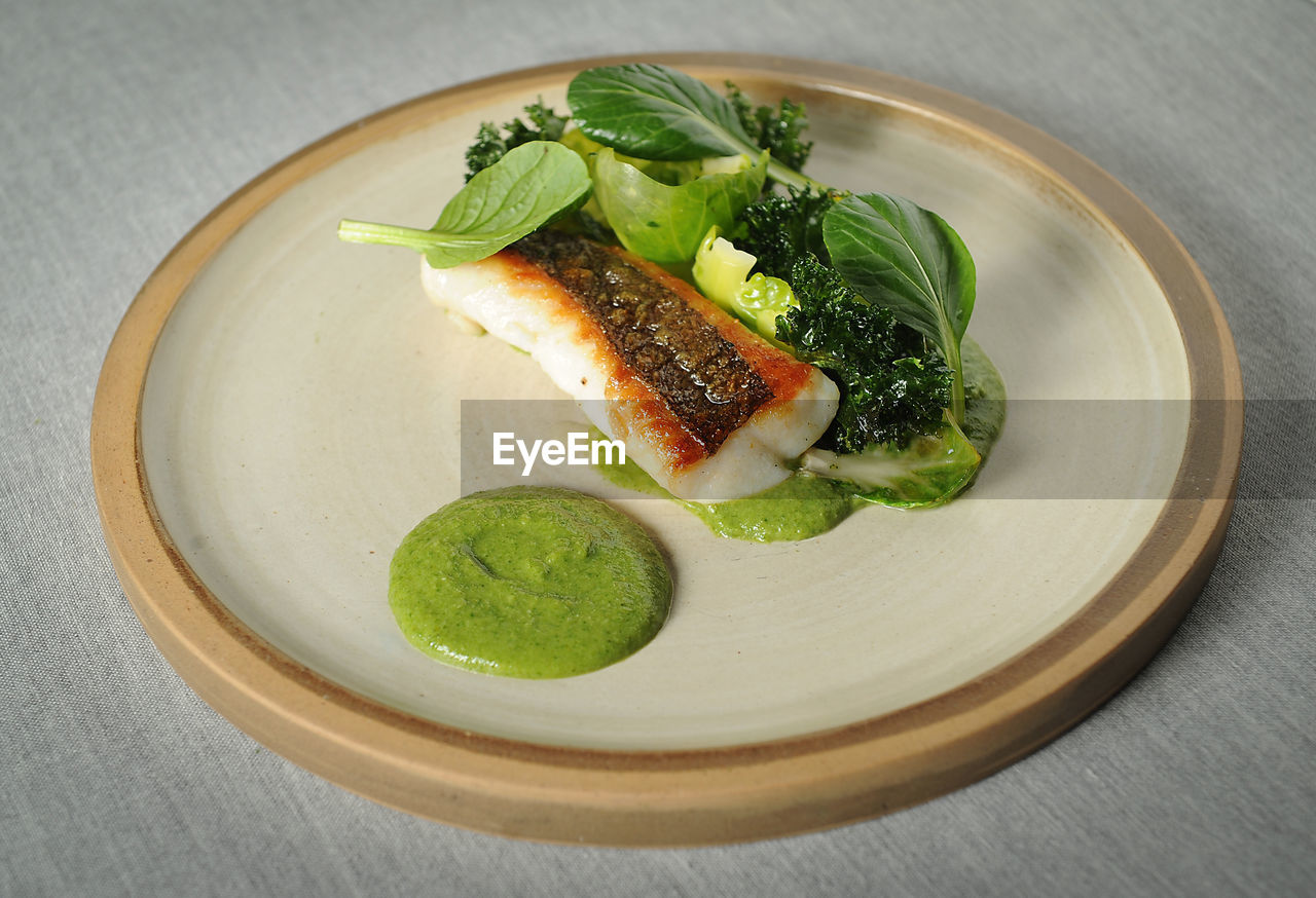 High angle view of fish salad in plate on table