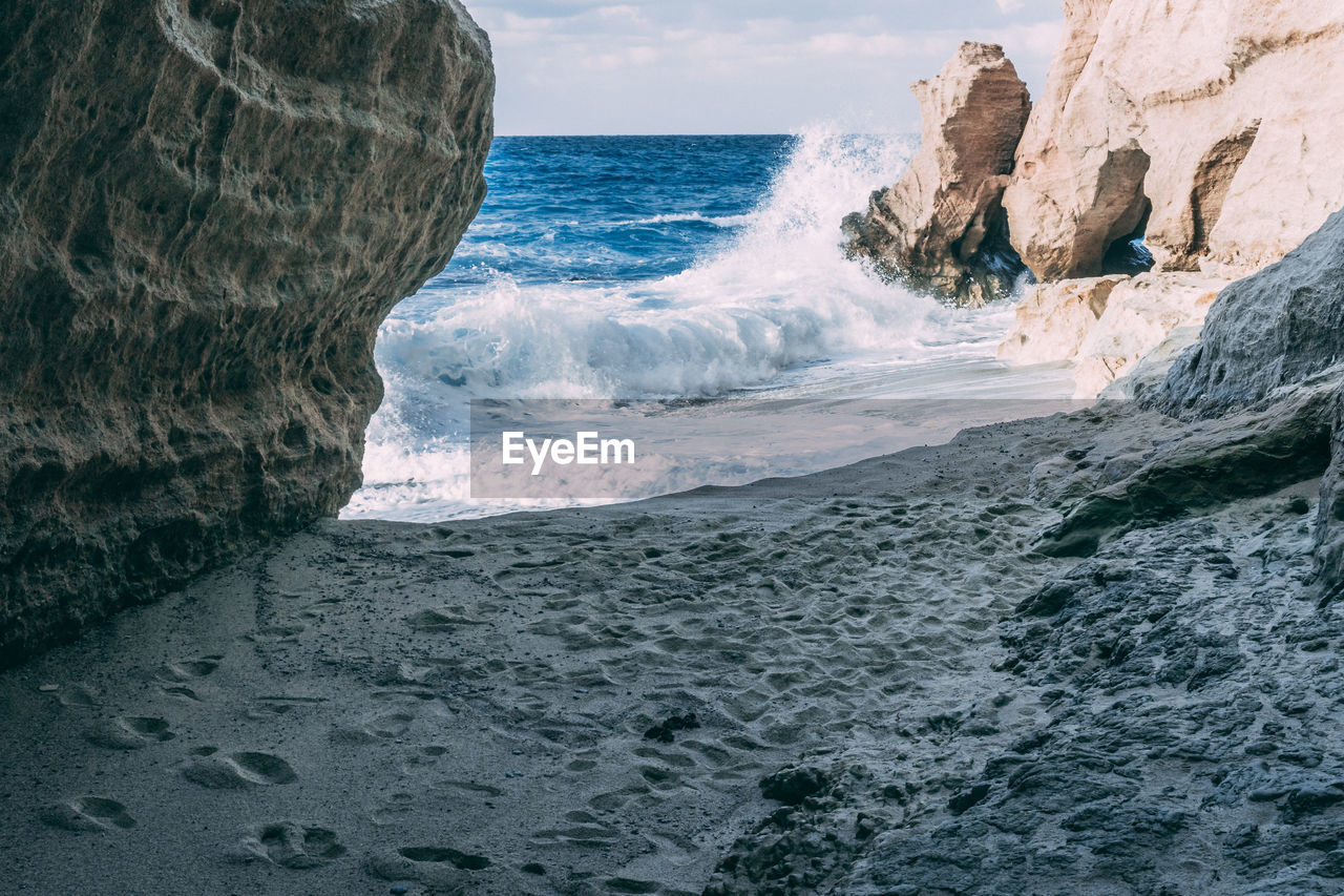 Waves splashing on rocks at beach