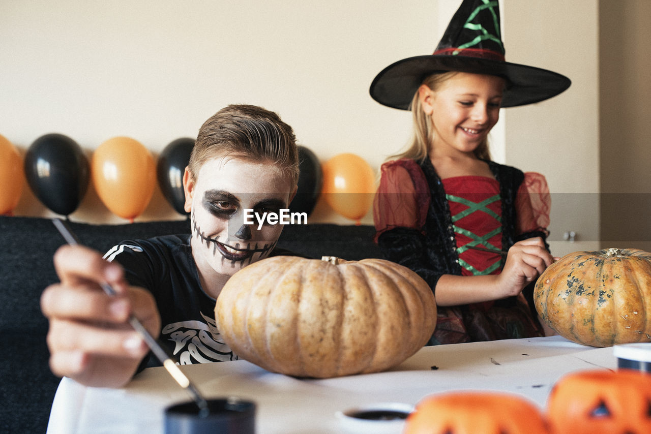 Portrait of smiling woman with pumpkins