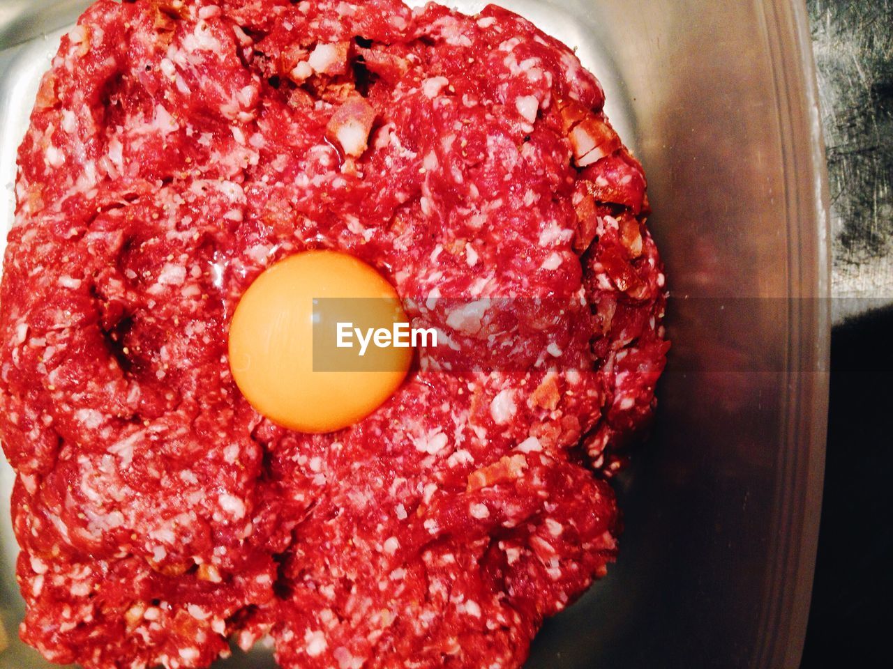 High angle view of beef with egg in container
