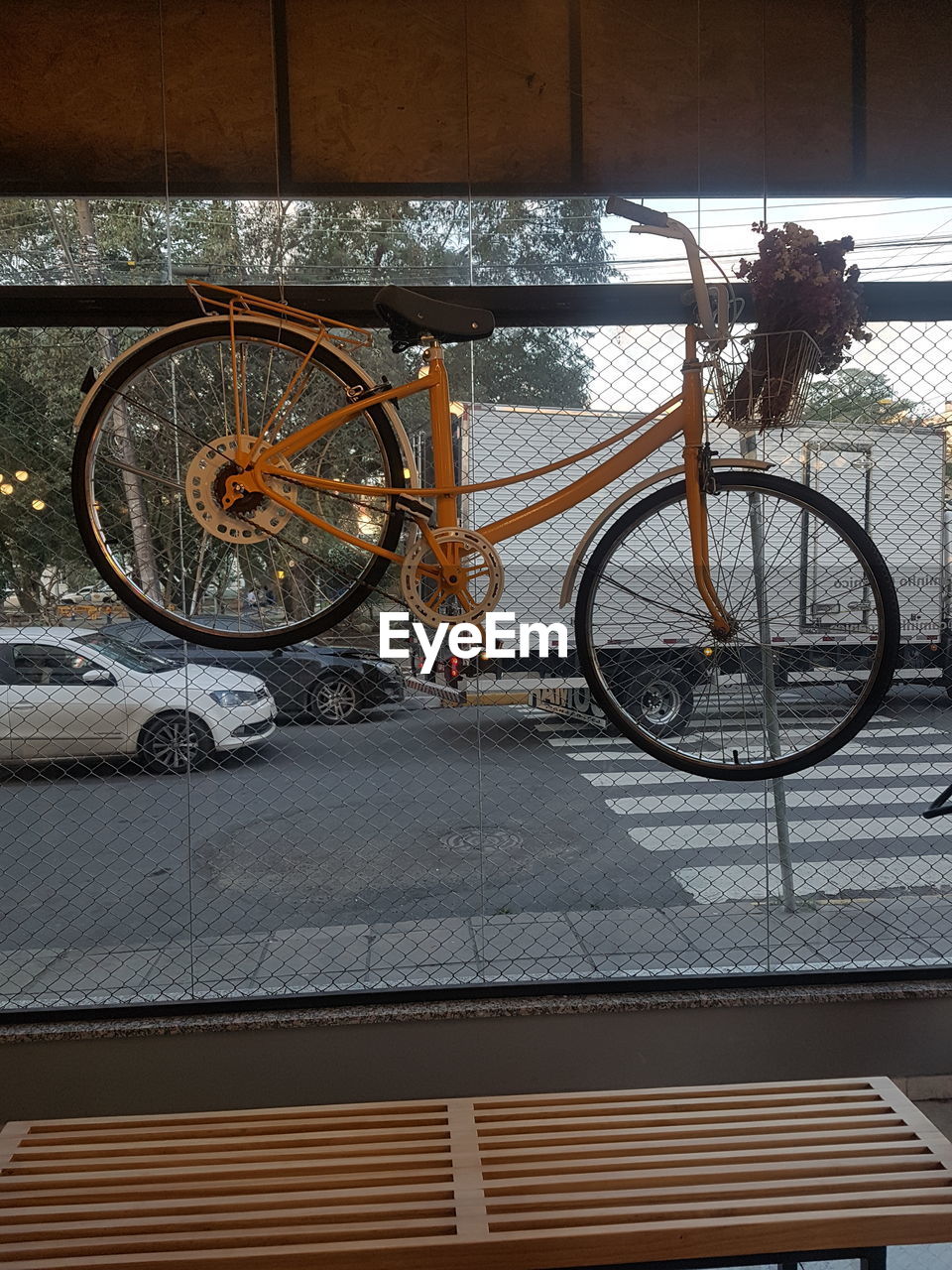 BICYCLE PARKED BY WALL