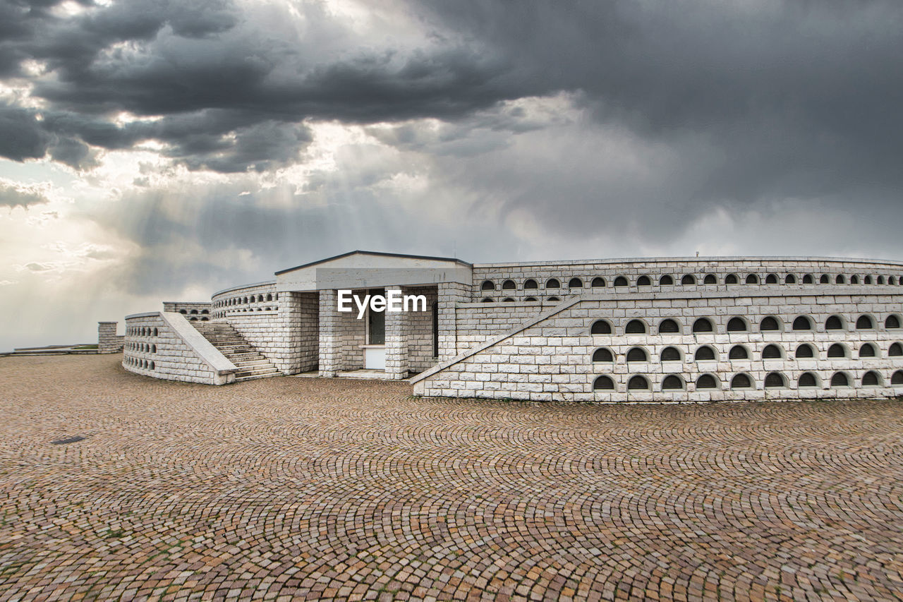 cloud, sky, architecture, built structure, nature, land, building exterior, beach, building, no people, dramatic sky, sand, outdoors, storm, overcast, travel destinations, day, environment, horizon, storm cloud, landscape, sea, water, travel