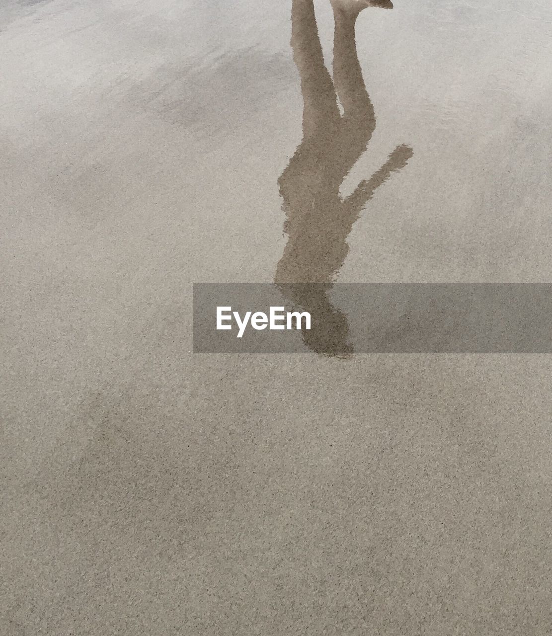 Reflection of woman at beach