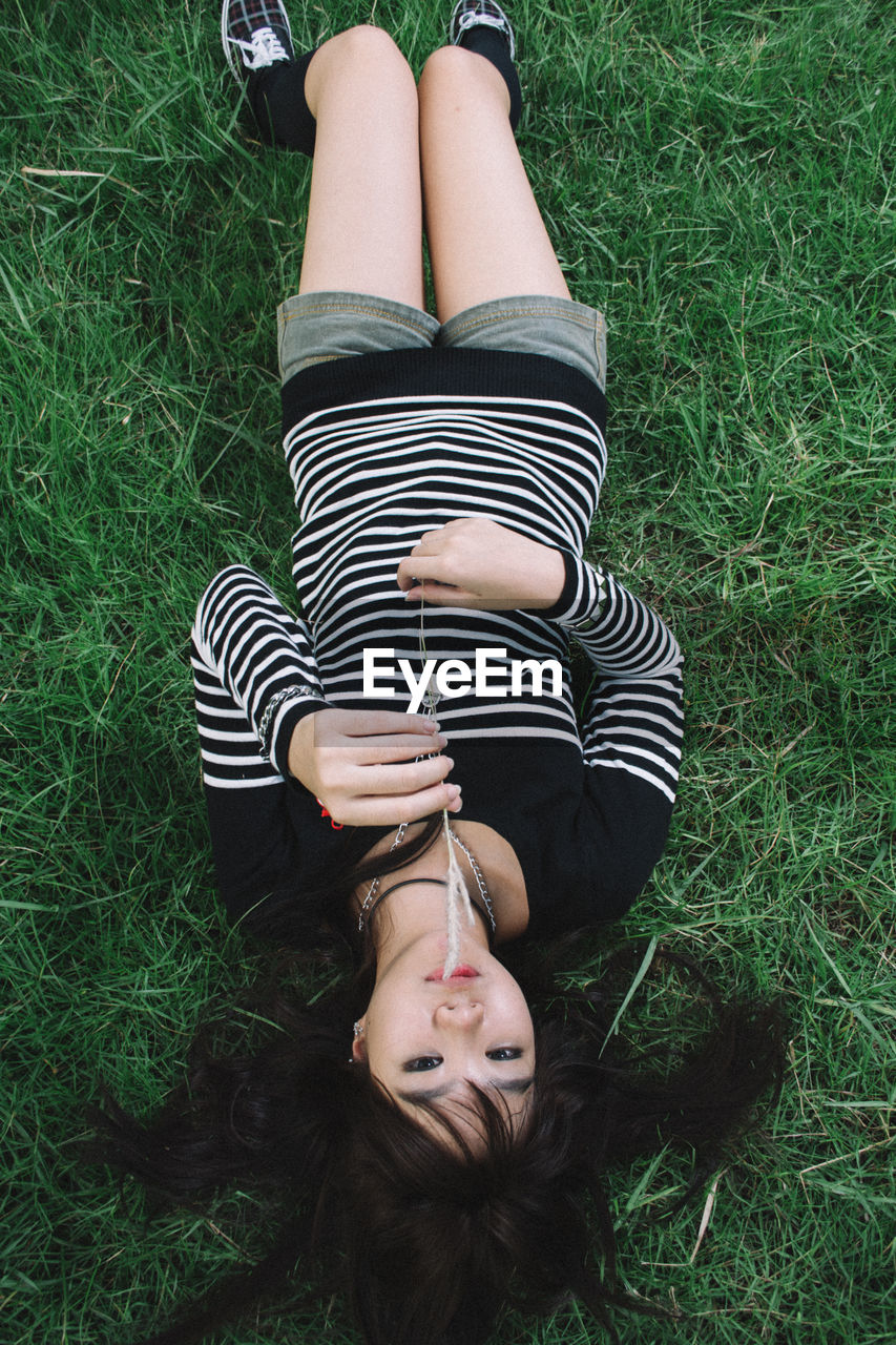 Low section of woman lying on grass