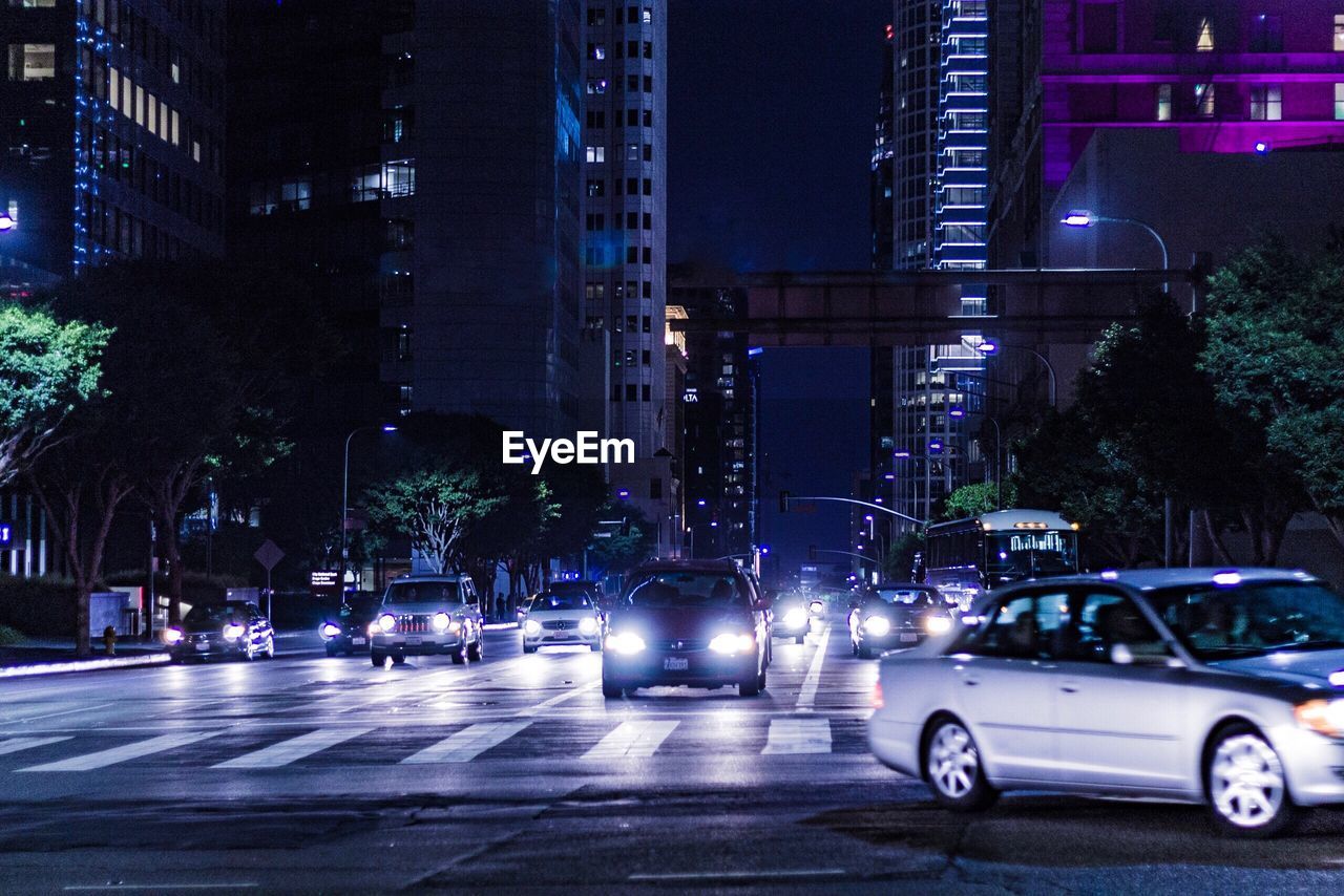 CARS ON ROAD AT NIGHT IN CITY