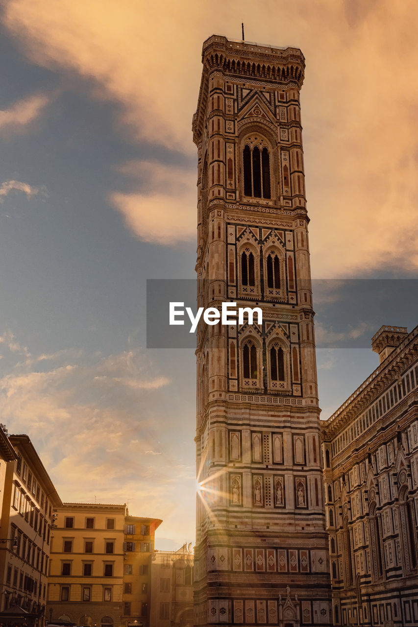 Low angle view of buildings against sky during sunset