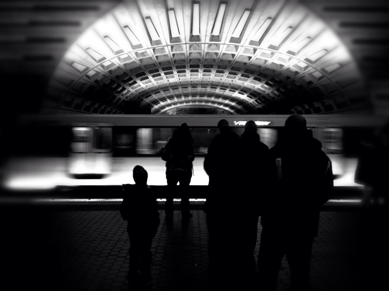 Silhouette people at metro station platform