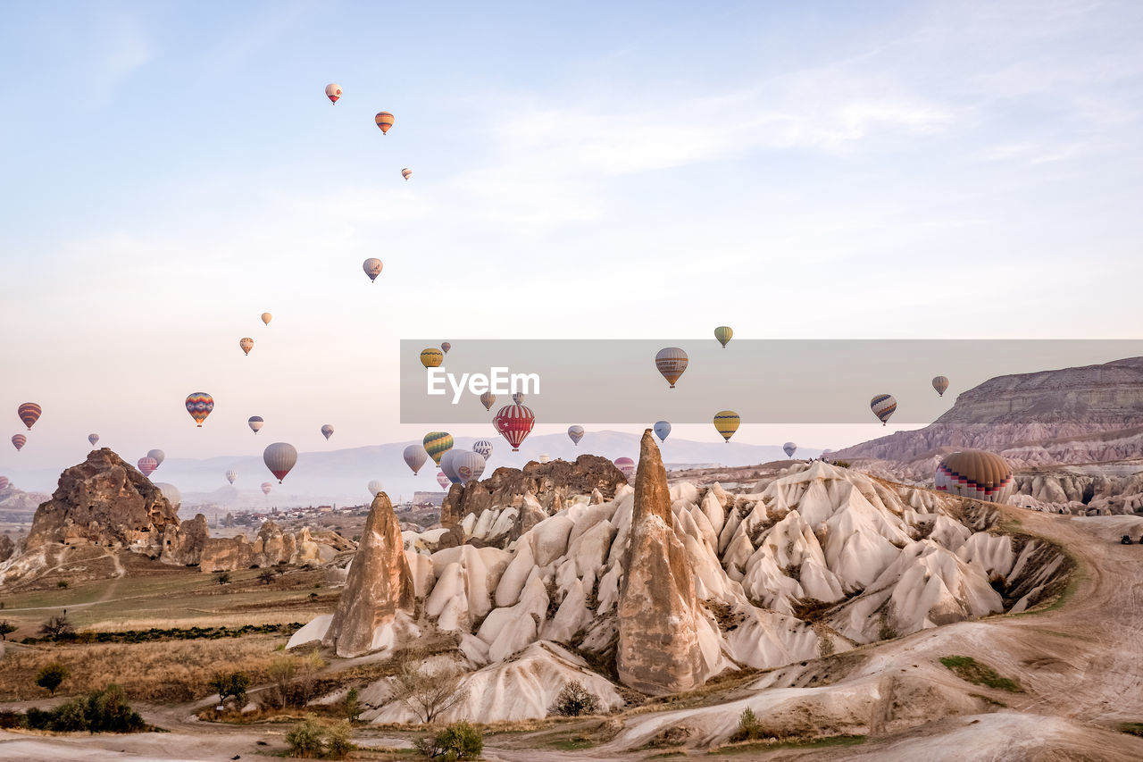 HOT AIR BALLOONS FLYING OVER ROCK FORMATION