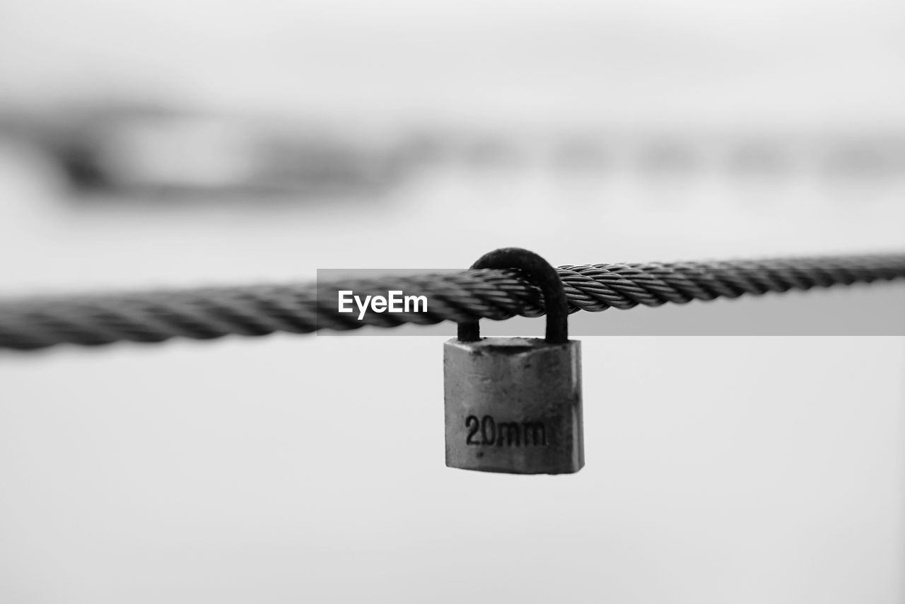 CLOSE-UP OF LOVE PADLOCKS ON RAILING AGAINST SKY