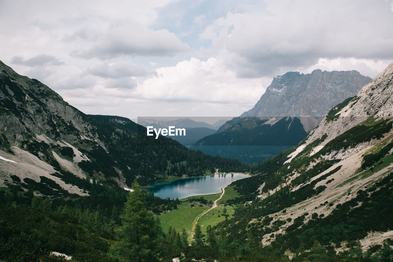 Scenic view of lake and mountains against sky