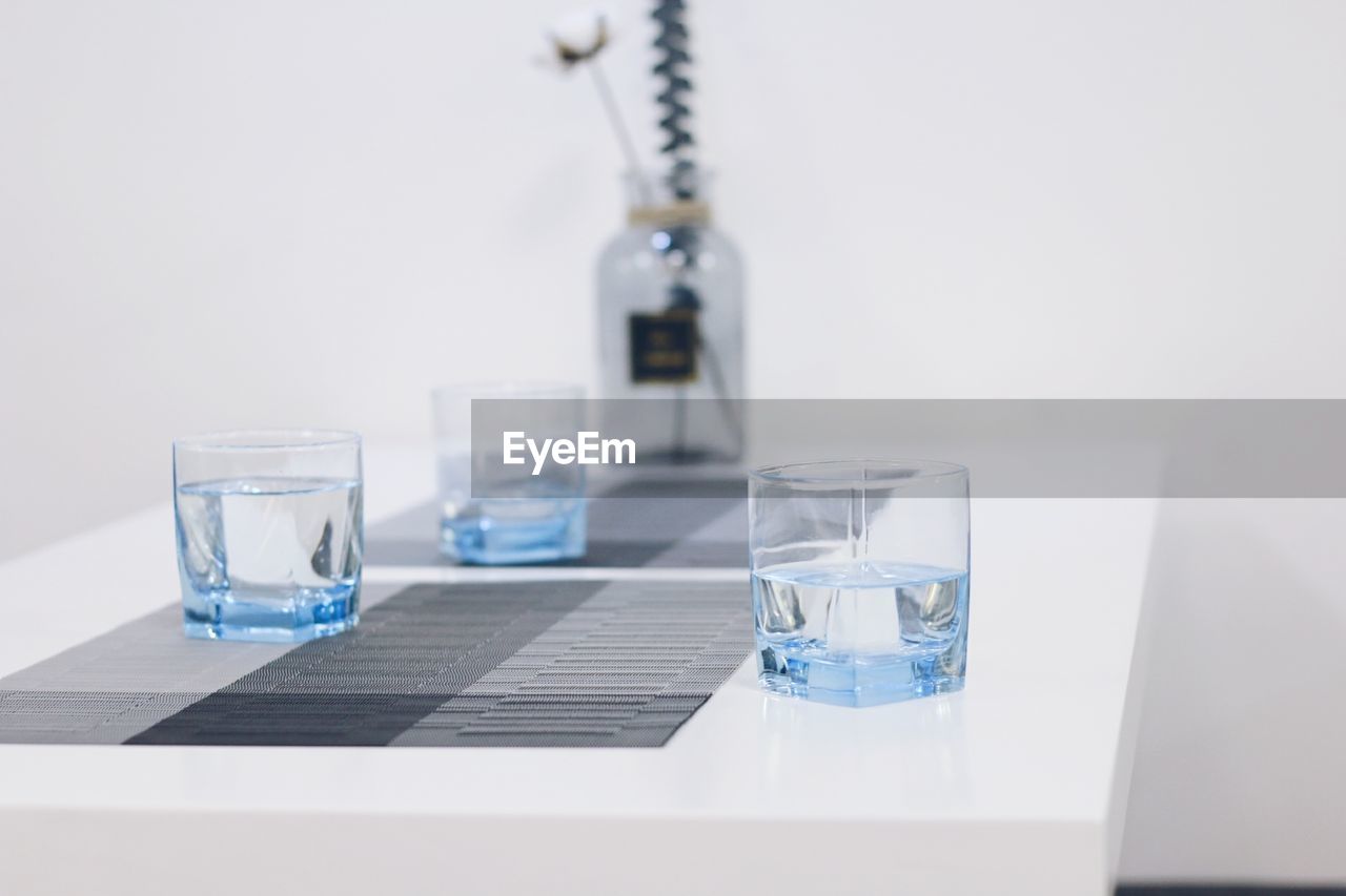 Water in glasses on table at office