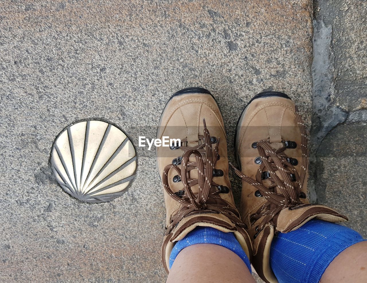 LOW SECTION OF PERSON STANDING ON STREET