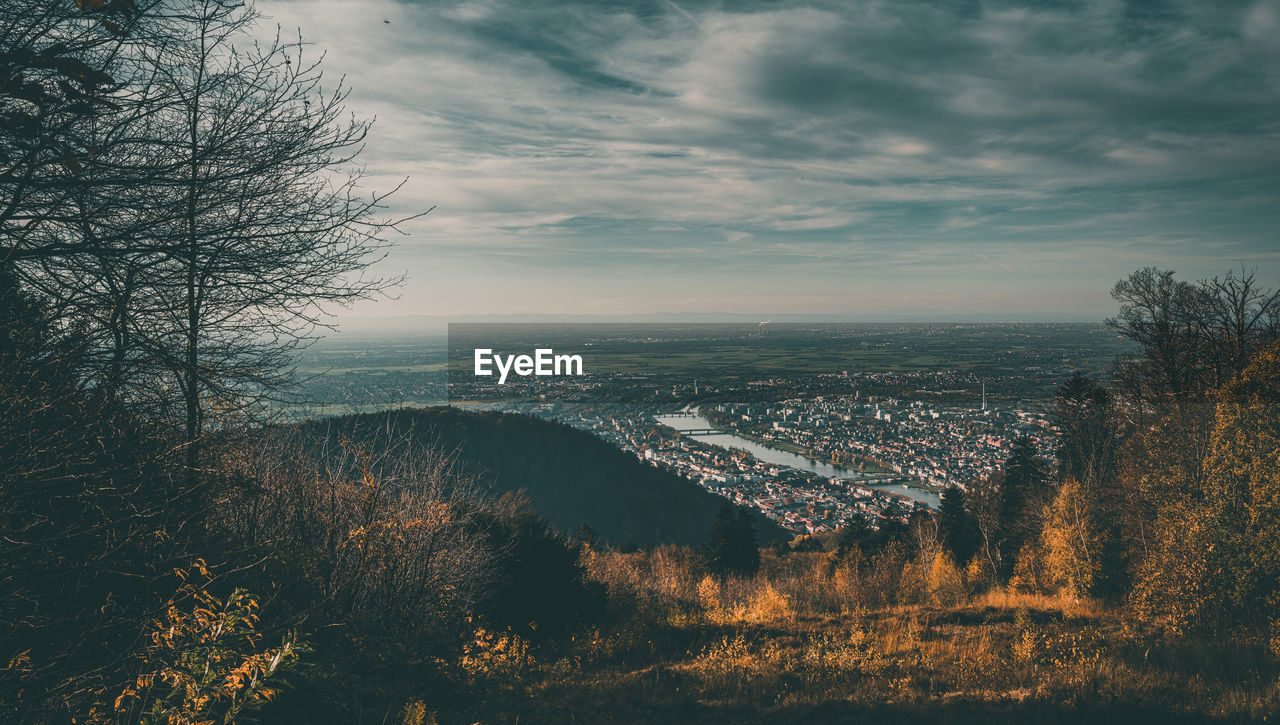 HIGH ANGLE VIEW OF CITY AGAINST SKY DURING SUNSET