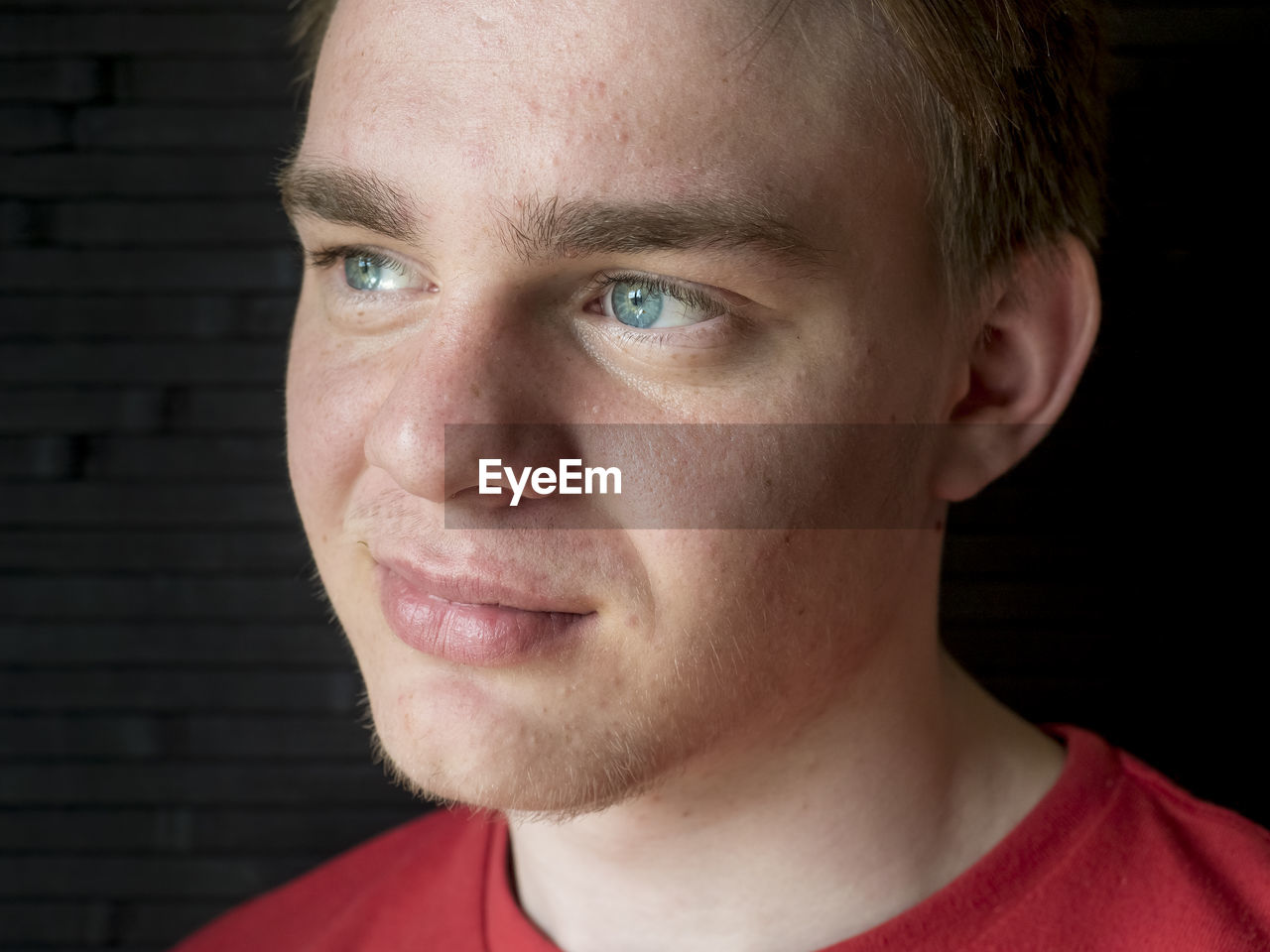 Close-up of thoughtful man against black background