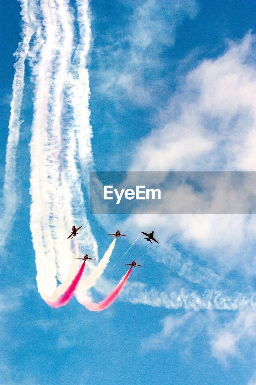 LOW ANGLE VIEW OF AIRSHOW AGAINST SKY