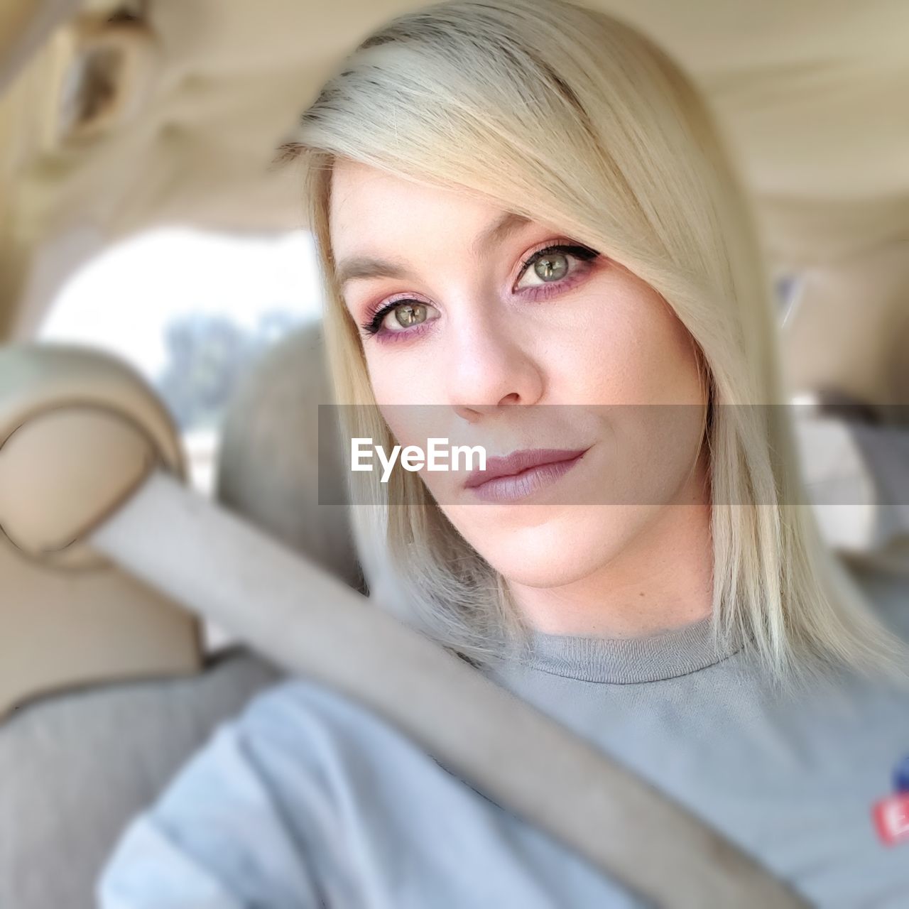 Portrait of beautiful woman sitting in car