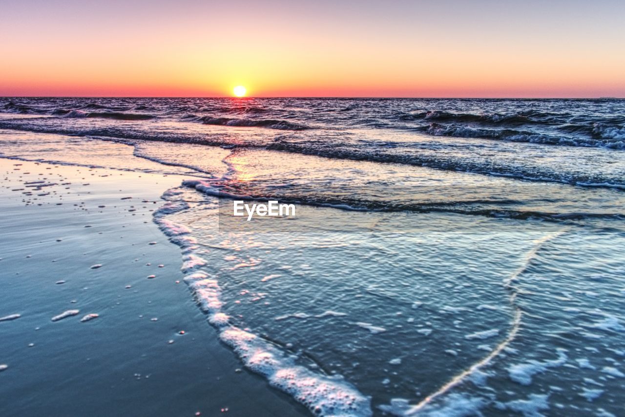 SCENIC VIEW OF BEACH DURING SUNSET