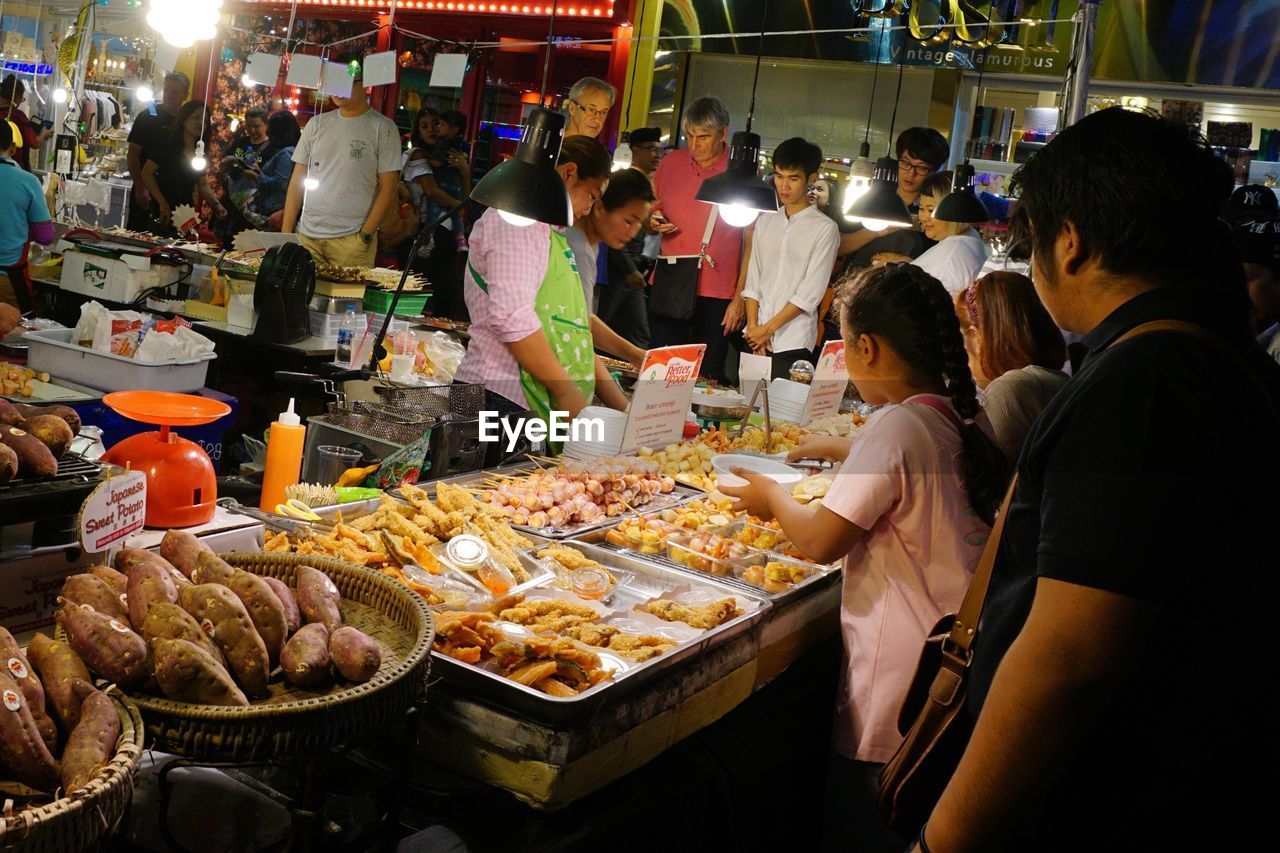 PEOPLE IN MARKET STALL