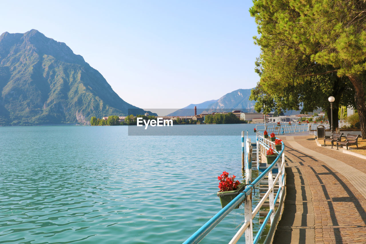 Scenic view of lake and mountains against clear sky