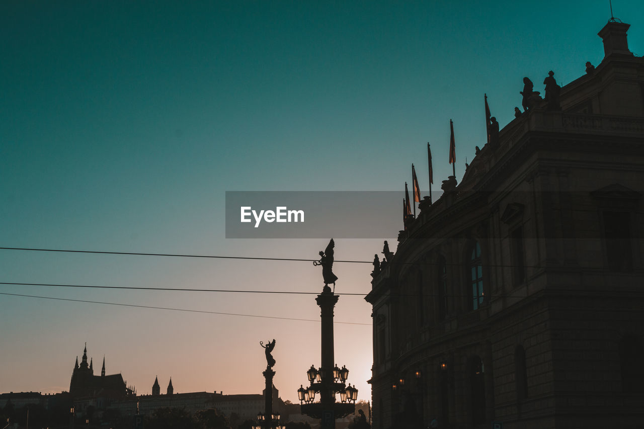 Low angle view of silhouette buildings against sky at dusk