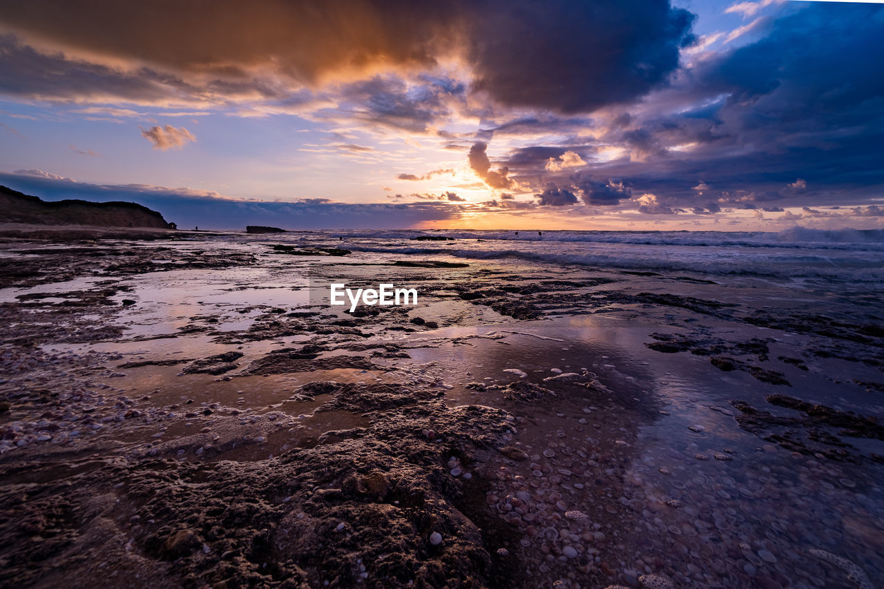 sky, sea, water, sunset, cloud, land, ocean, environment, dawn, beauty in nature, nature, coast, scenics - nature, beach, horizon, landscape, wave, shore, travel destinations, evening, dramatic sky, travel, reflection, seascape, sunlight, no people, sun, wind wave, outdoors, tranquility, motion, sand, tide, tourism, coastline, horizon over water, blue, tranquil scene, body of water, cloudscape, holiday