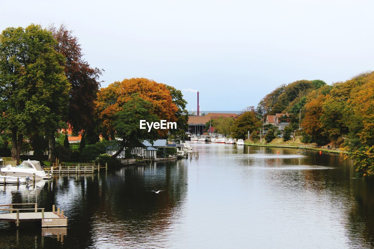 River amidst trees against sky during autumn