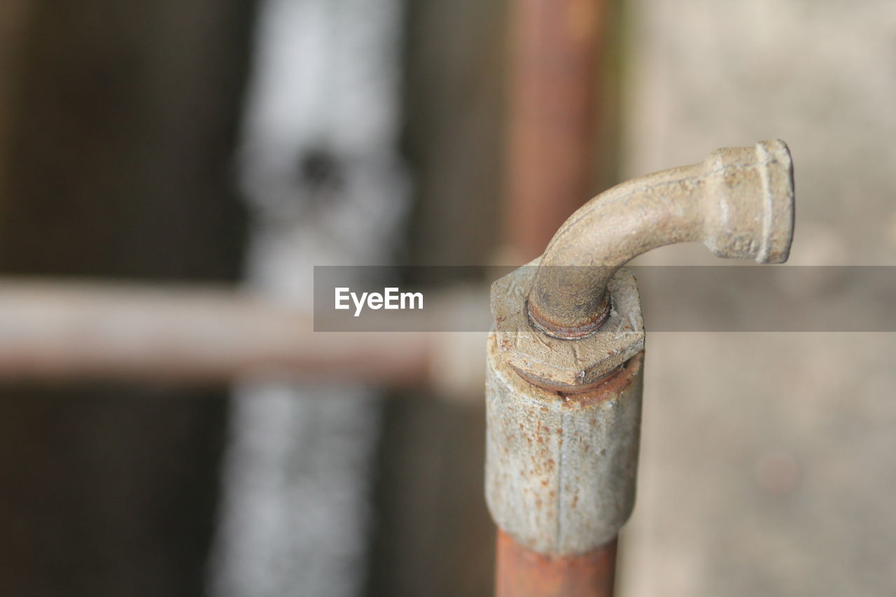 CLOSE-UP OF OLD FAUCET