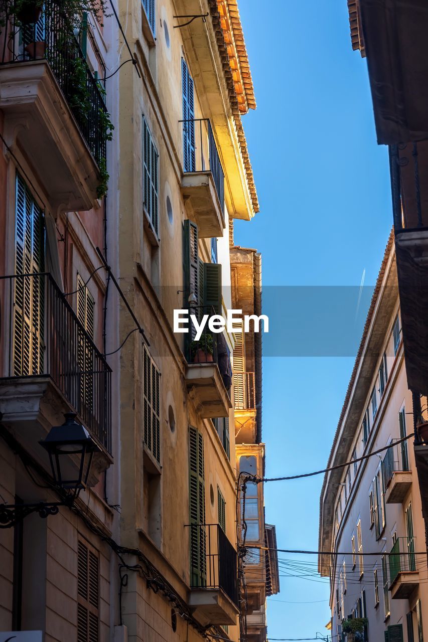 Low angle view of buildings against blue sky