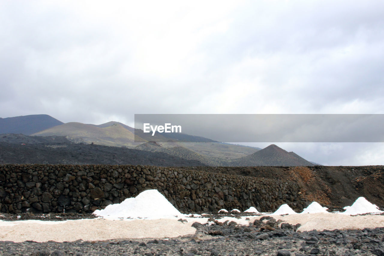 LANDSCAPE WITH MOUNTAIN RANGE IN BACKGROUND