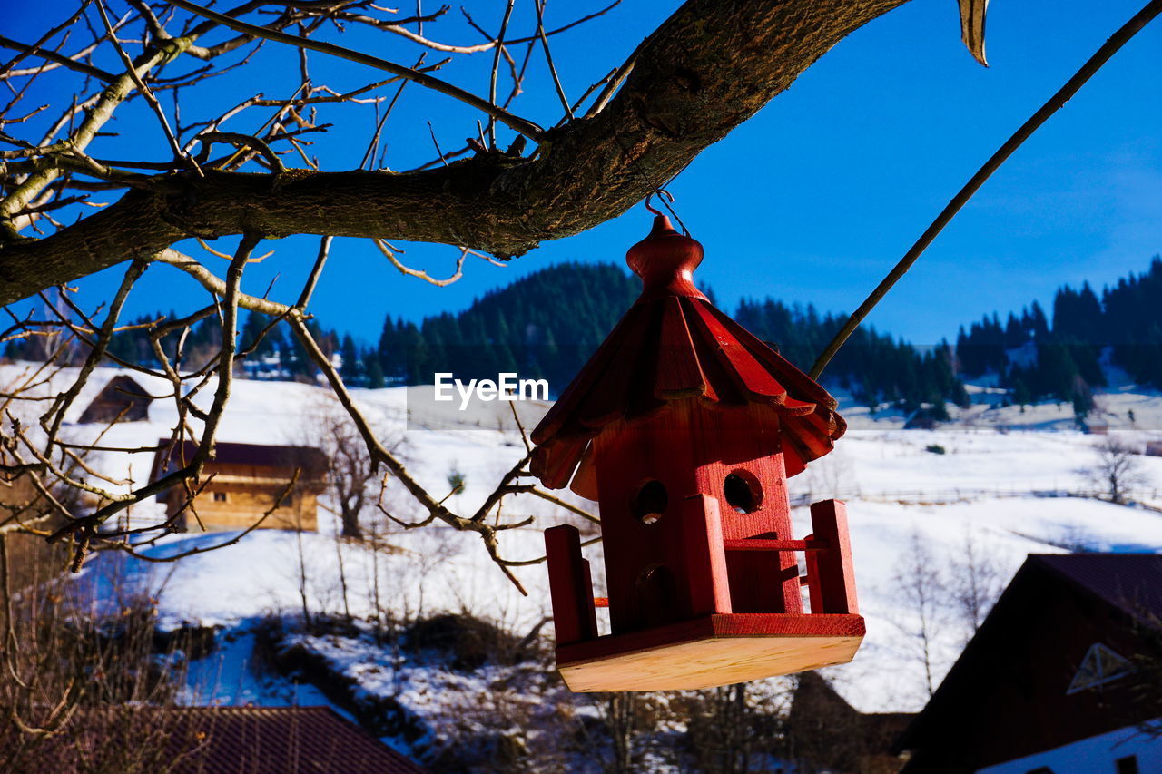 Built structure on snow covered landscape against sky