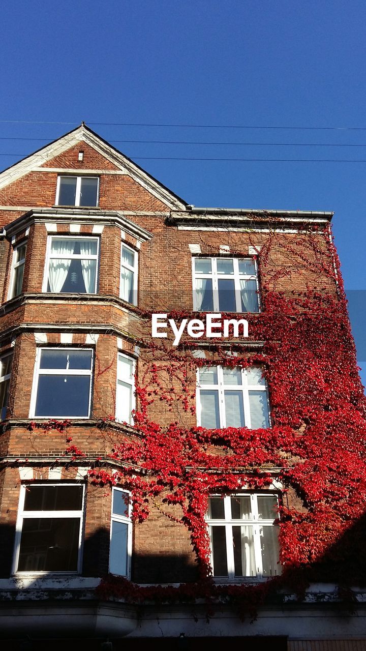 Low angle view of red building against clear sky