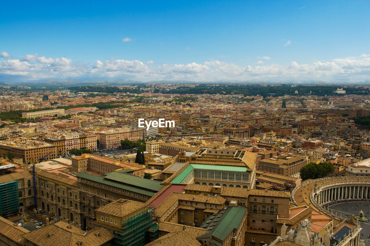 HIGH ANGLE VIEW OF CITYSCAPE AGAINST SKY