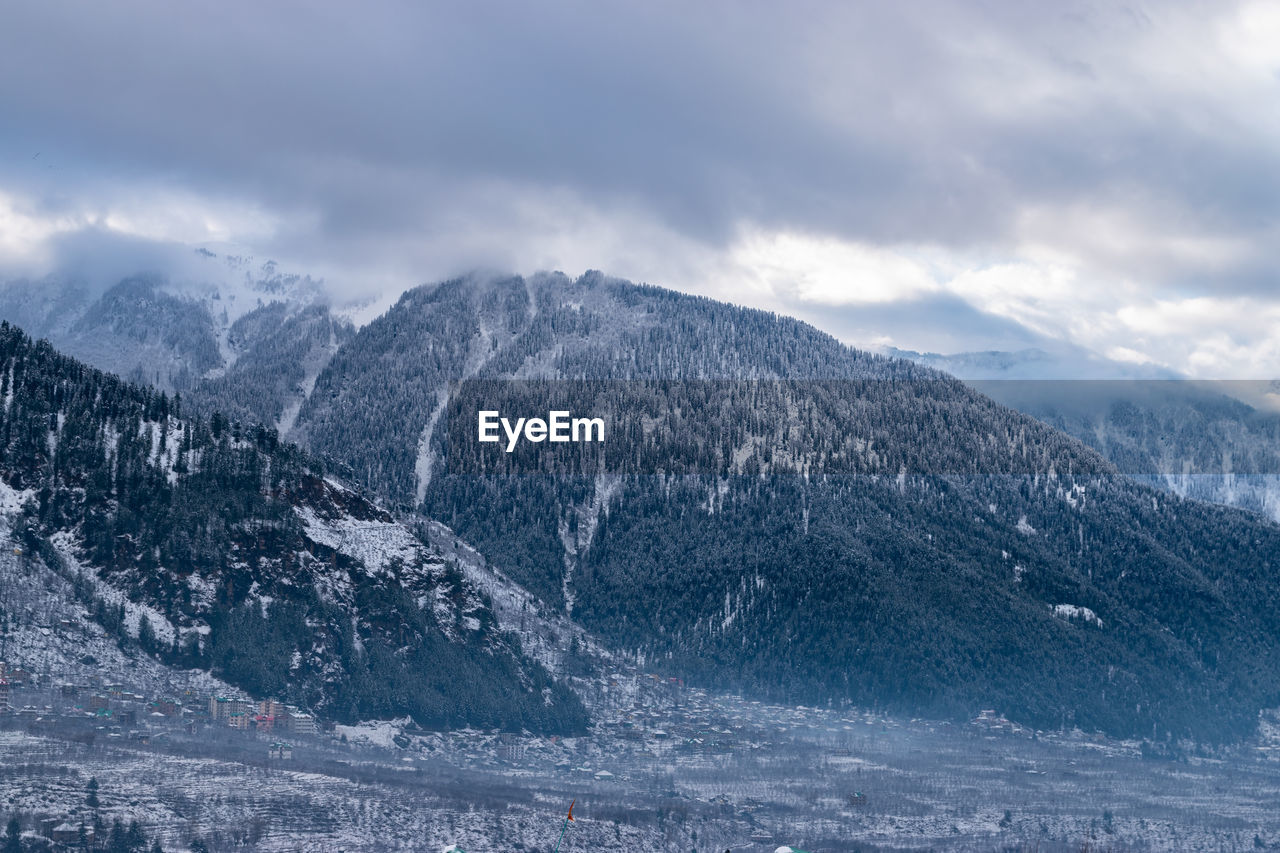 Scenic view of snowcapped mountains against sky