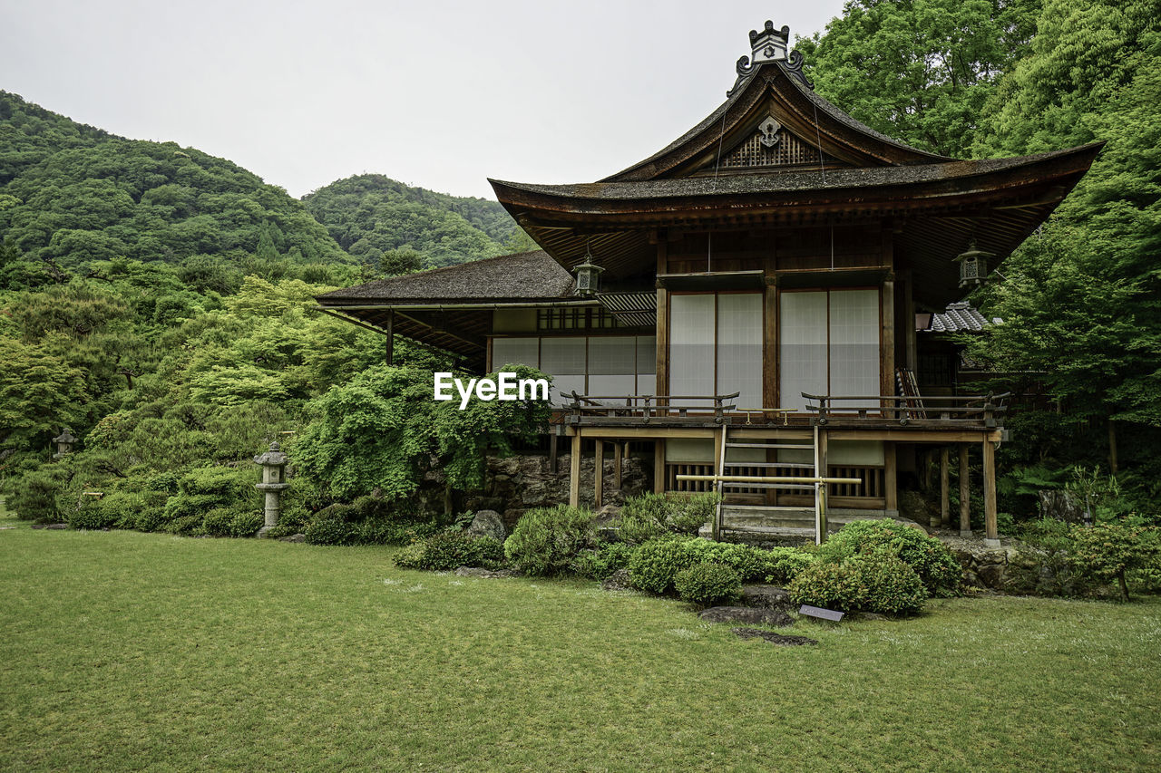 BUILT STRUCTURE WITH TREES IN FOREGROUND