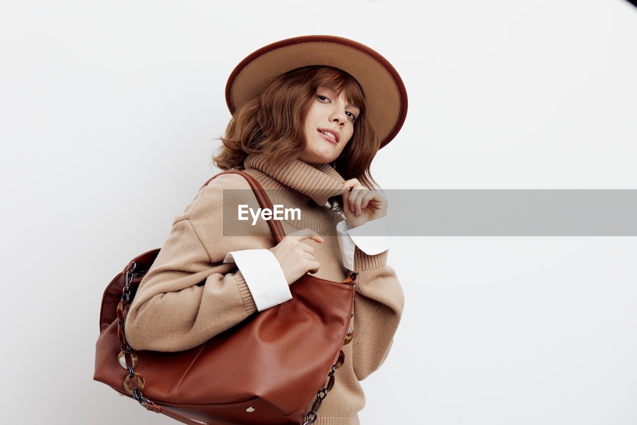 portrait of woman wearing hat against white background