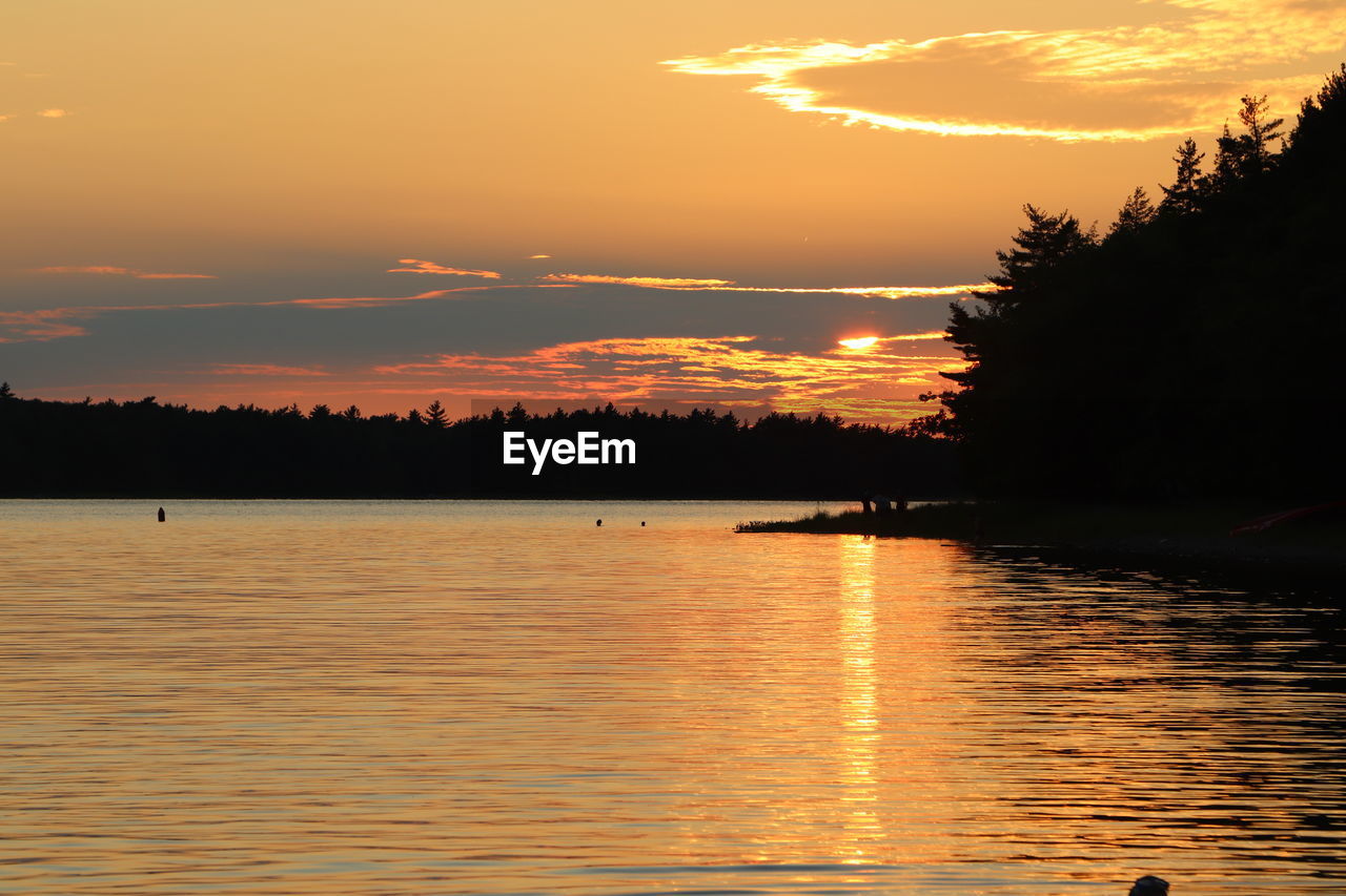 SCENIC VIEW OF LAKE AGAINST ORANGE SKY DURING SUNSET