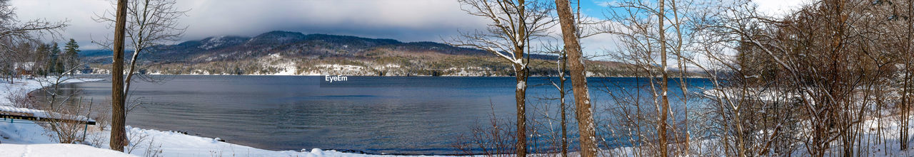 SCENIC VIEW OF LAKE AGAINST SNOW DURING WINTER