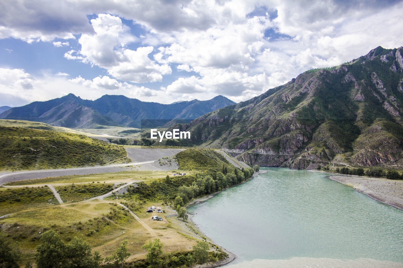 Scenic view of lake and mountains against sky