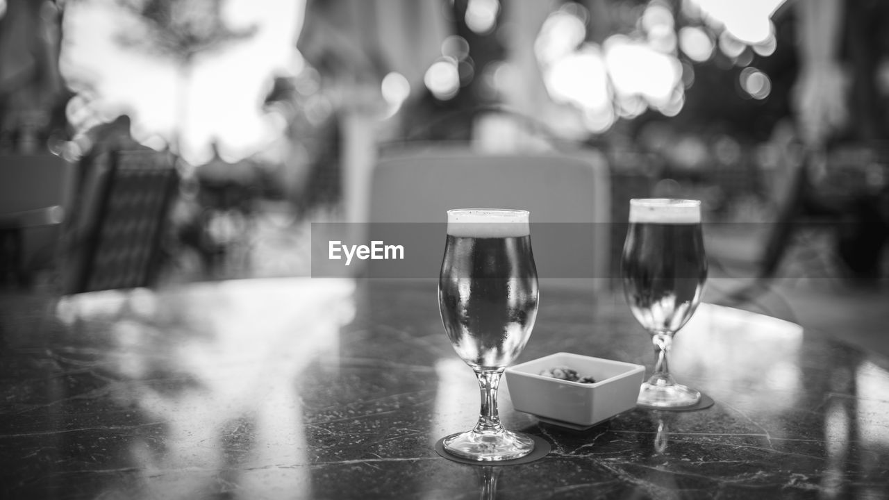 Close-up of beer in glasses on table at outdoor restaurant