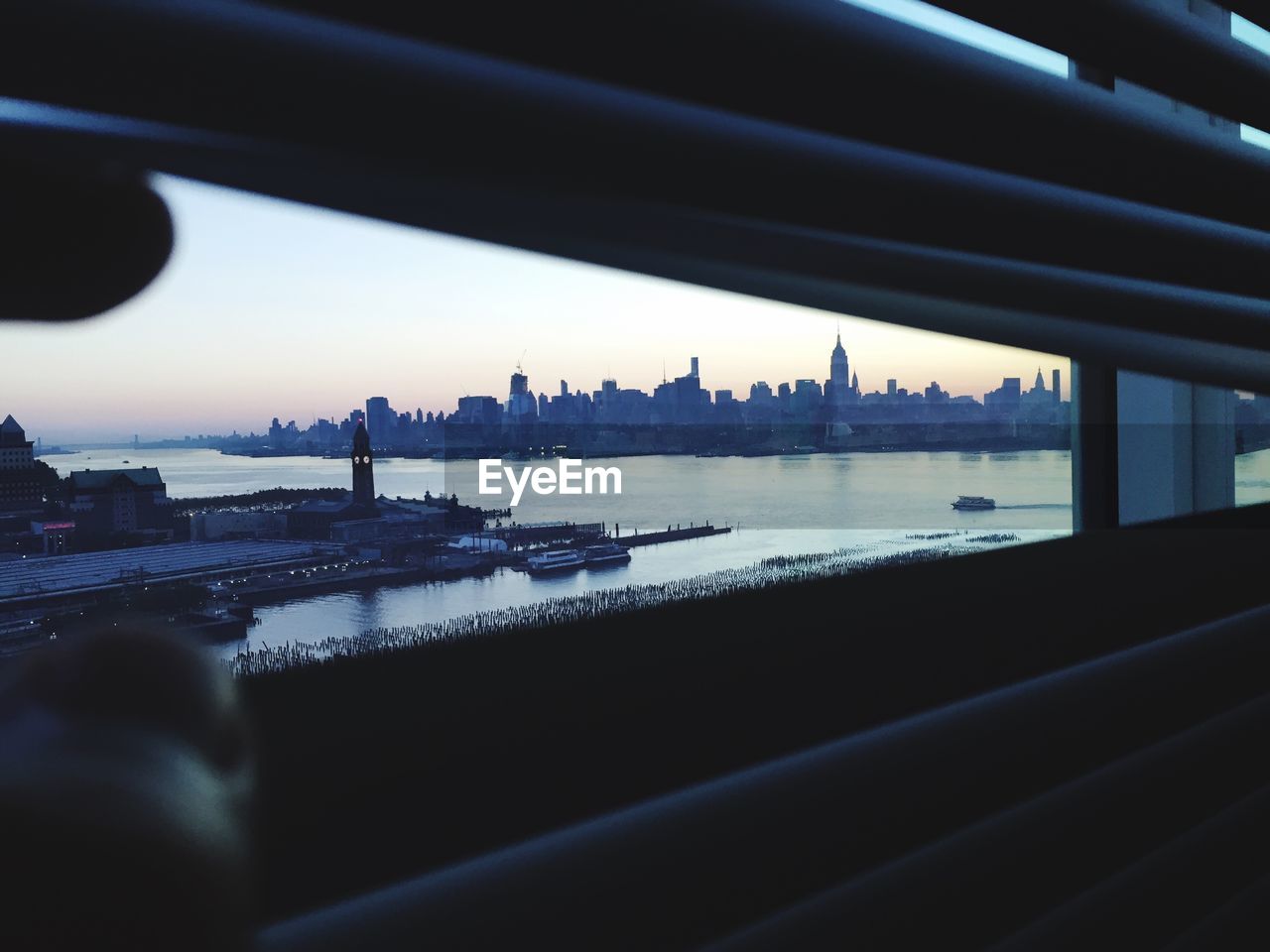 Cityscape seen through blinds window