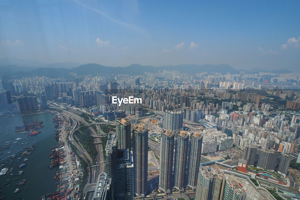 AERIAL VIEW OF BUILDINGS AGAINST SKY IN CITY