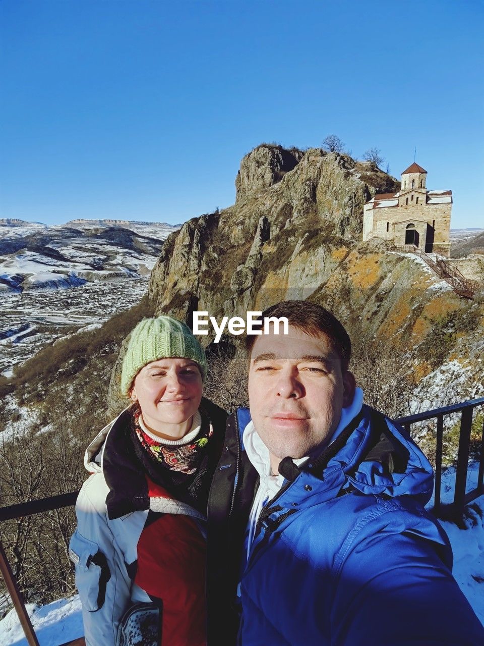 two people, mountain, adult, winter, men, snow, leisure activity, cold temperature, mountain range, adventure, nature, sky, mountaineering, togetherness, clothing, sports, women, vacation, warm clothing, portrait, day, clear sky, travel destinations, trip, holiday, travel, blue, activity, hiking, smiling, scenics - nature, walking, mature adult, summit, female, outdoors, happiness, winter sports, emotion, lifestyles, looking at camera, waist up, sunny, beauty in nature, recreation, young adult, skiing, sunlight, person, landscape, standing, tourism, friendship, tourist, environment, positive emotion, ski holiday, bonding, extreme sports