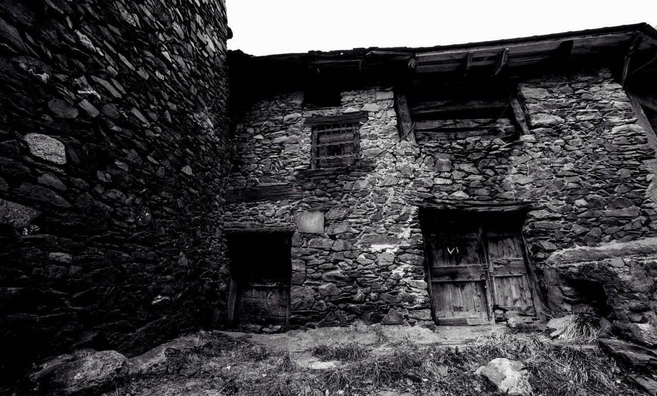 Low angle view of abandoned stone house