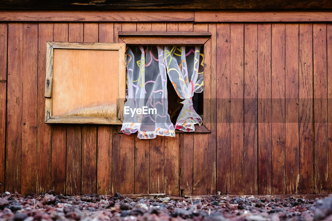 CLOTHES HANGING ON WOODEN DOOR OF HOUSE