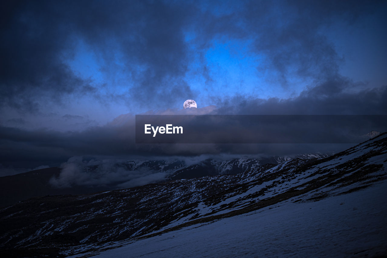 Scenic view of snow covered mountains against sky