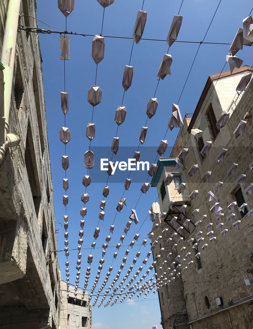 Low angle view of buildings against clear blue sky