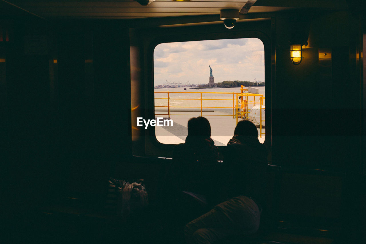 People sitting in boat by window