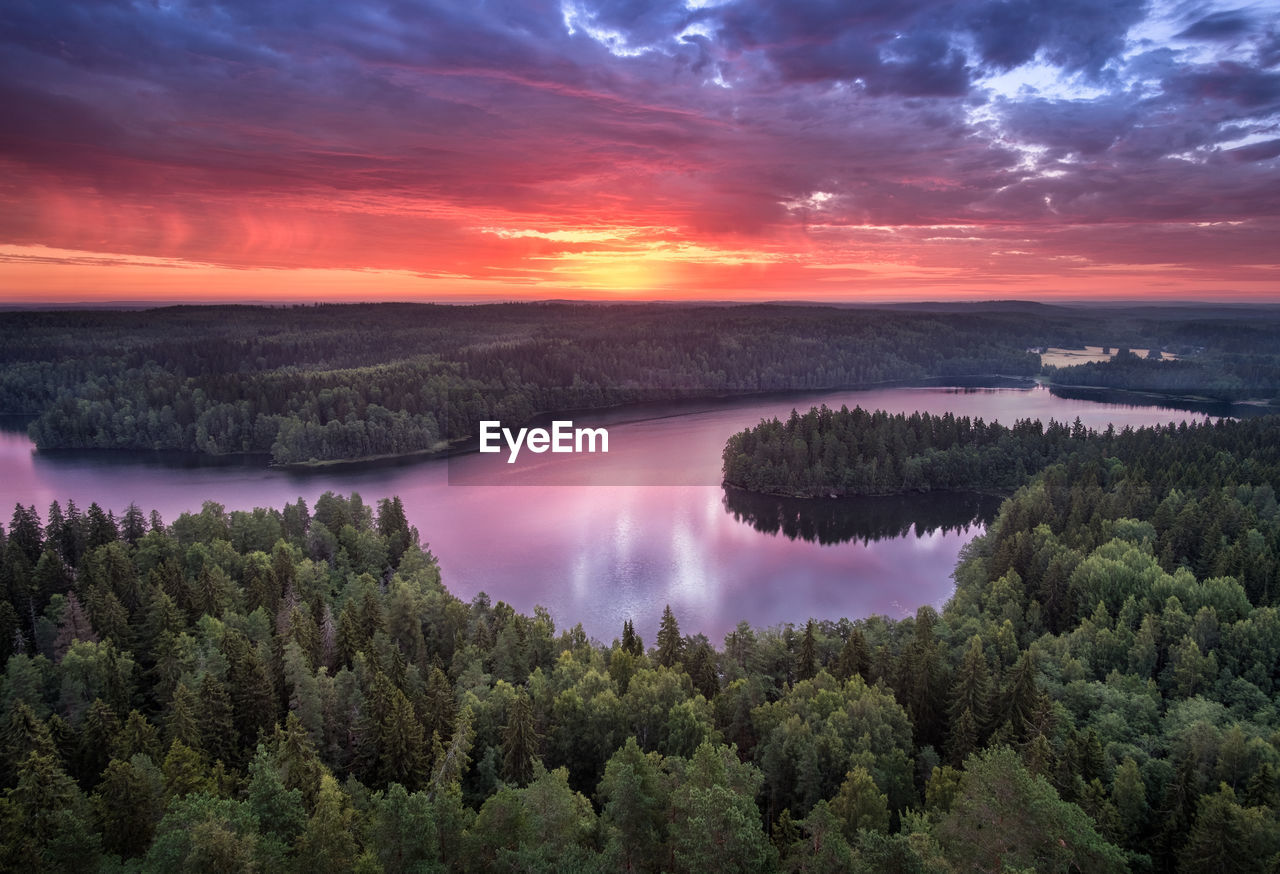 Scenic view of lake against sky at sunset