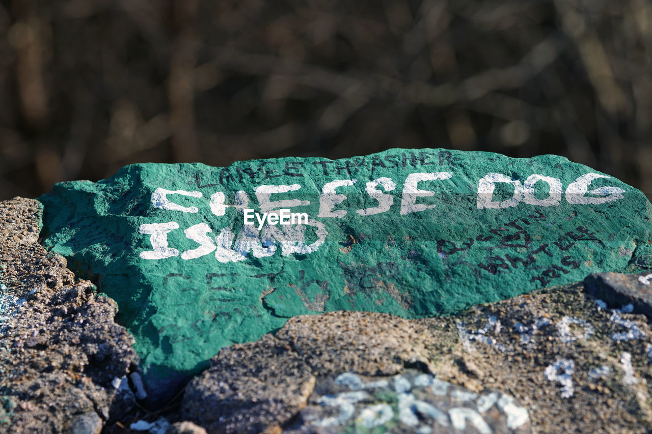 Close-up of text on painted rocks