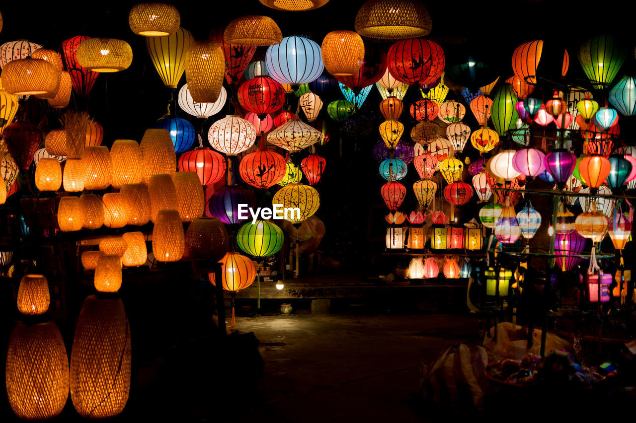 ILLUMINATED LANTERNS HANGING FOR SALE AT MARKET STALL